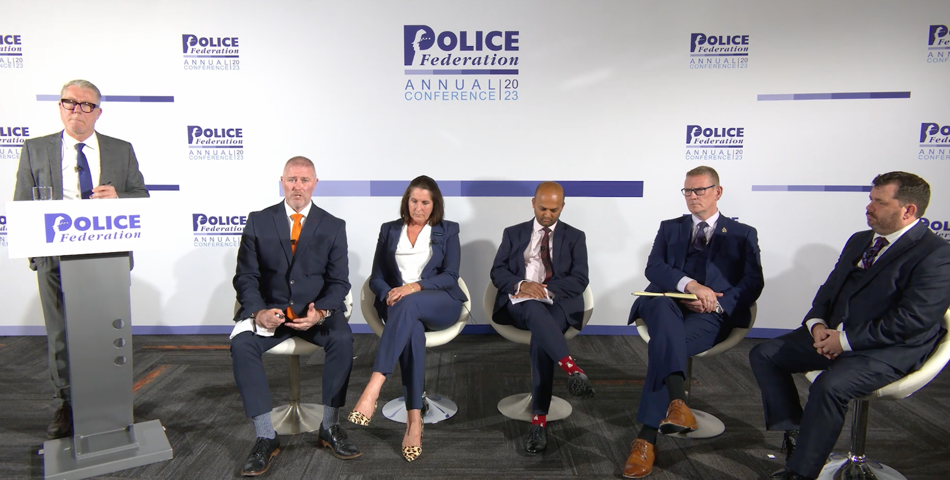 The panel members at the conference session.